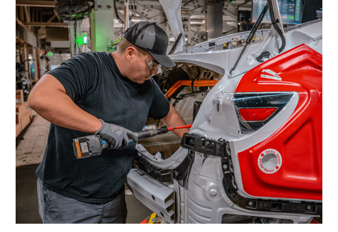 Tesla Employee working on the interior of a car