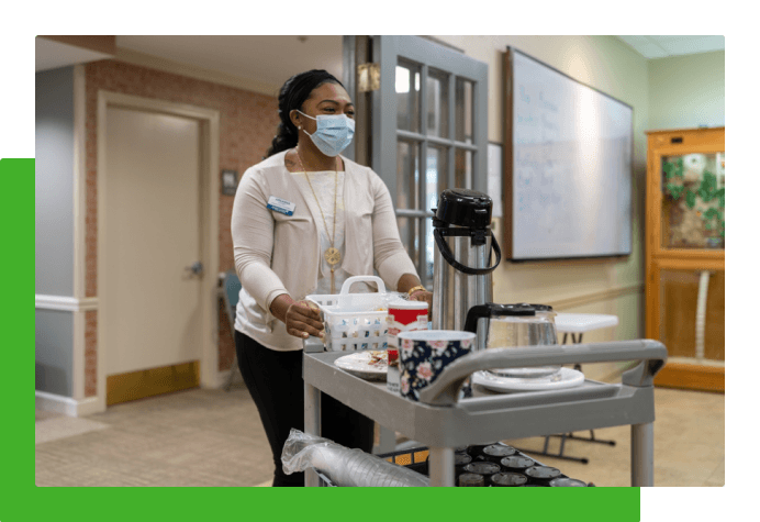Employee in mask walking with cart
