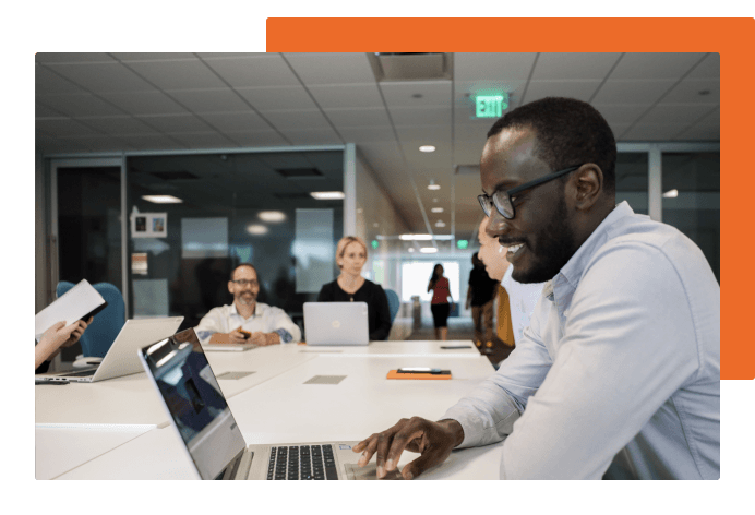 Person on laptop in a conference room 