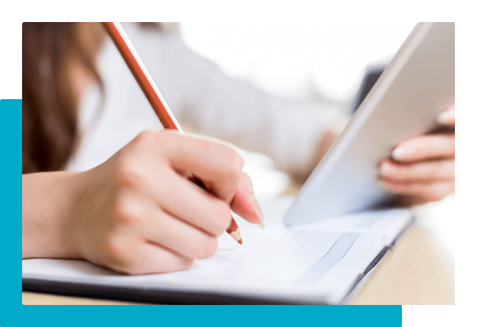 Student using a tablet and taking notes