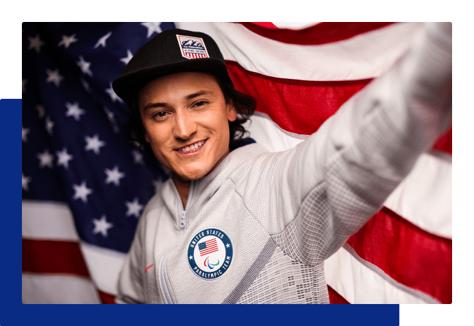 Athlete smiling and holding the American flag