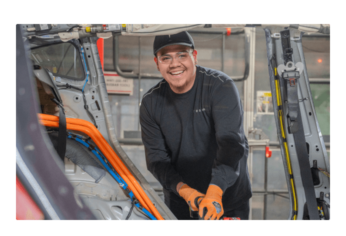 Smiling employee working in a factory 