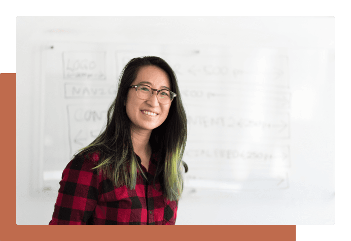 Smiling Wellstar student in front of a whiteboard
