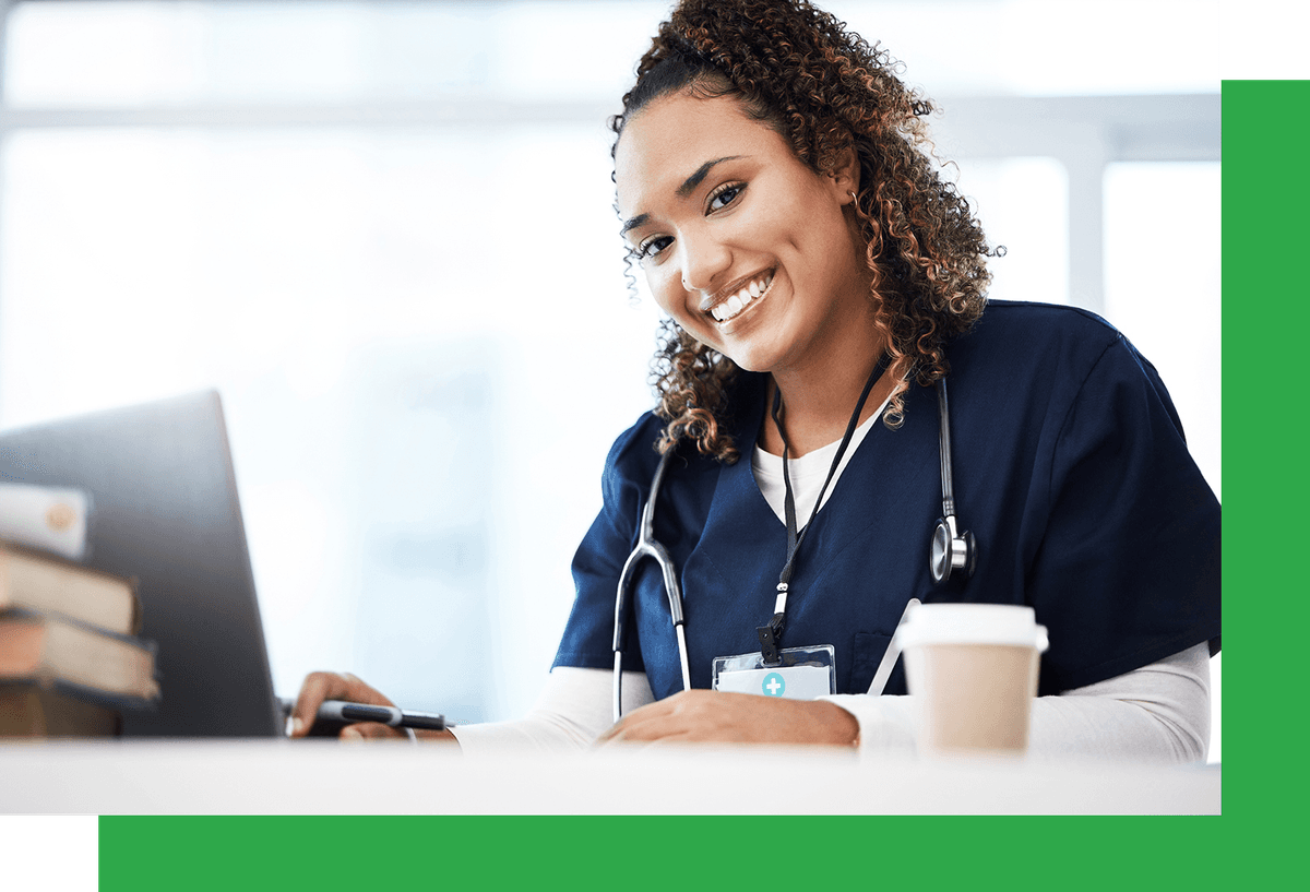 Smiling medical professional at a computer 