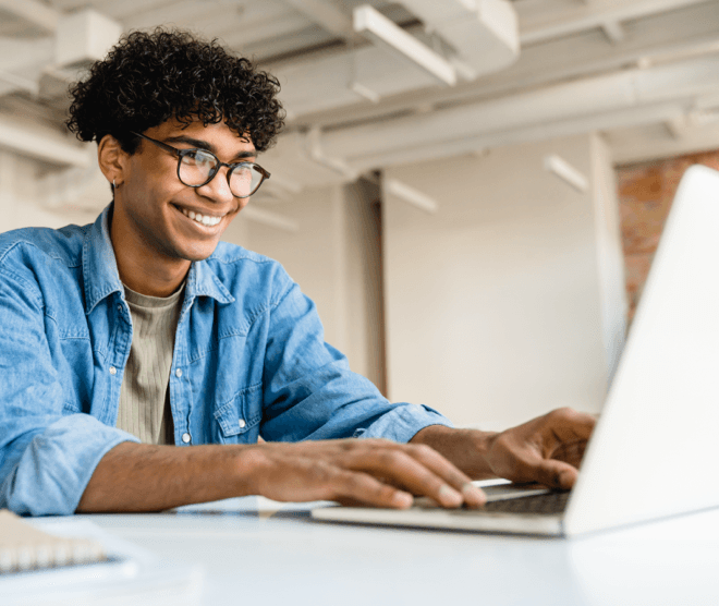 Man smiling with computer 