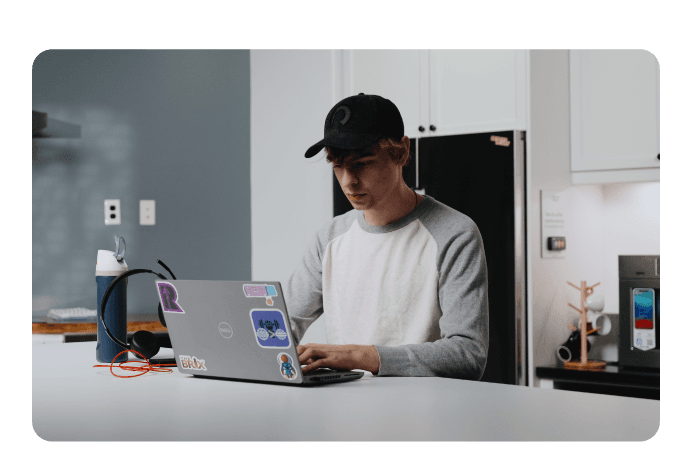 Couple smiling while sitting at computer