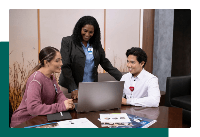 Employees looking at laptop