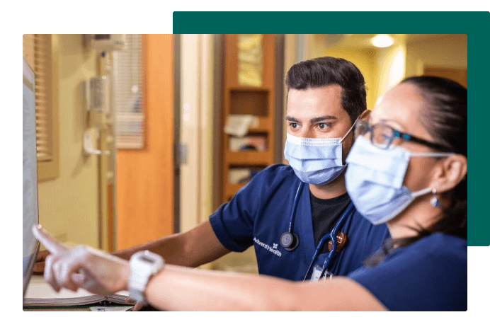 Team members looking at computer