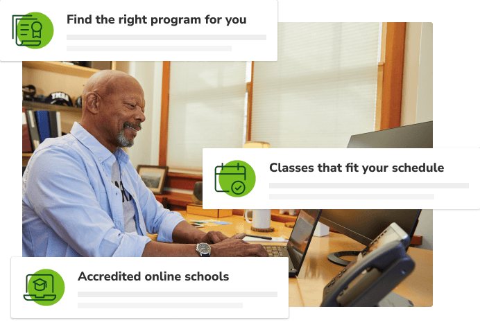 Man sitting in chair typing on laptop