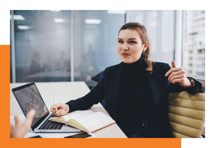 Student smiling and celebrating at their graduation with balloons