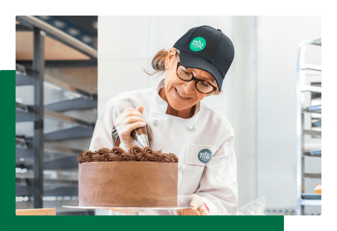 Team Member decorating a cake