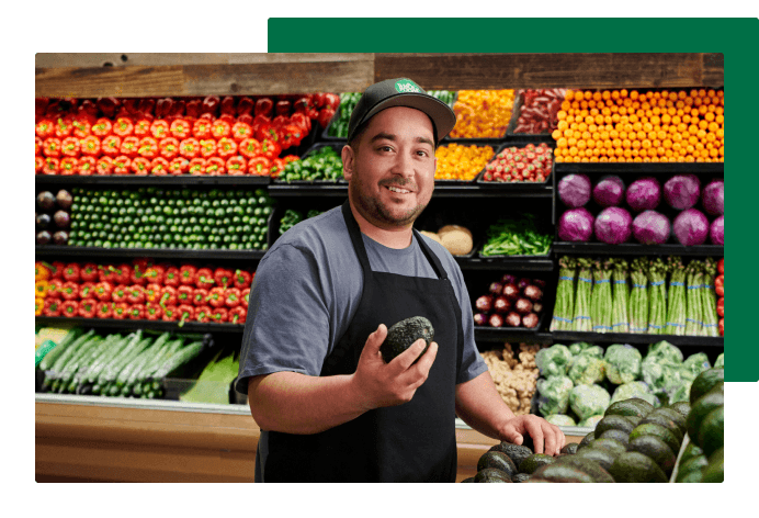 Smiling Team Member stocking produce