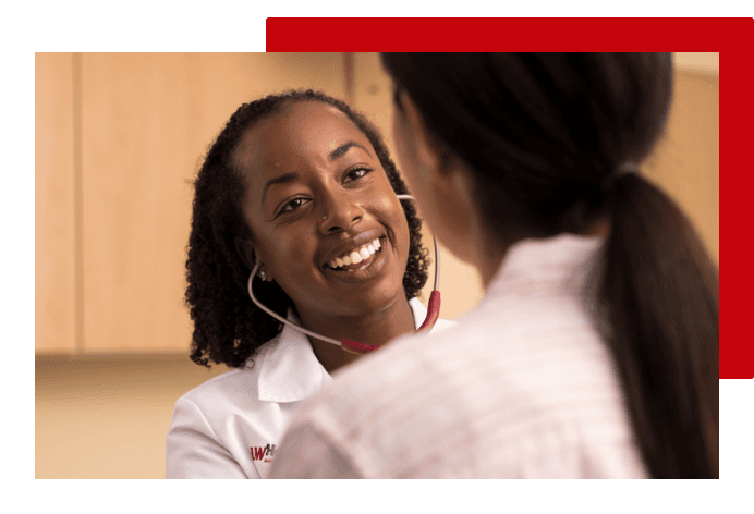 Doctor smiling while treating patient