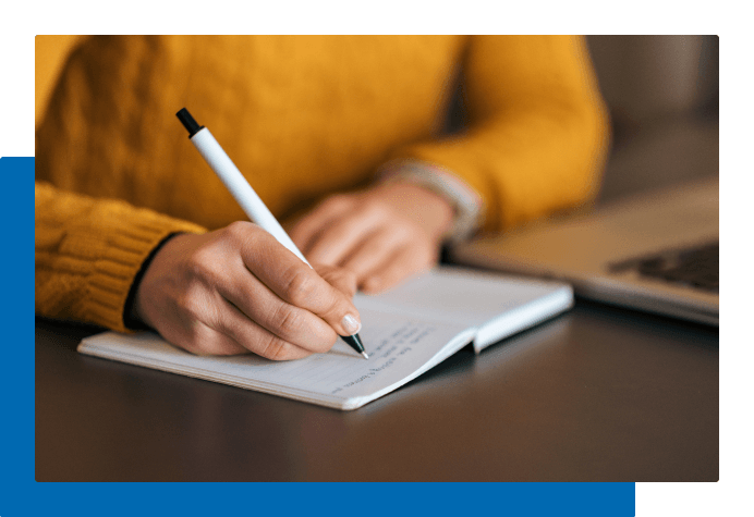 Person writing in notebook