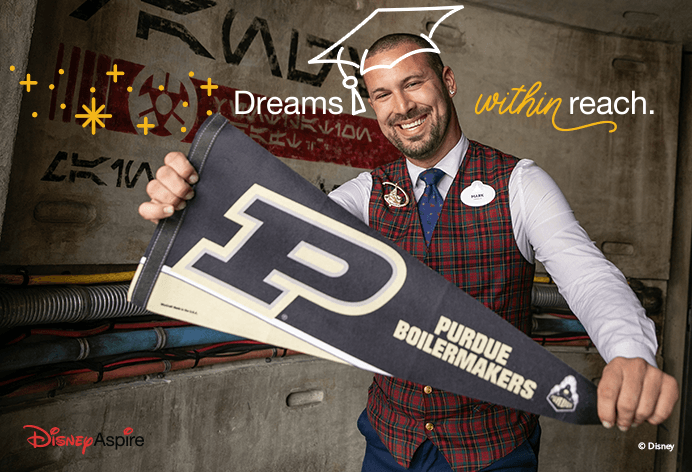 Dreams within reach; Man holding a Purdue banner wearing an illustrated grad cap