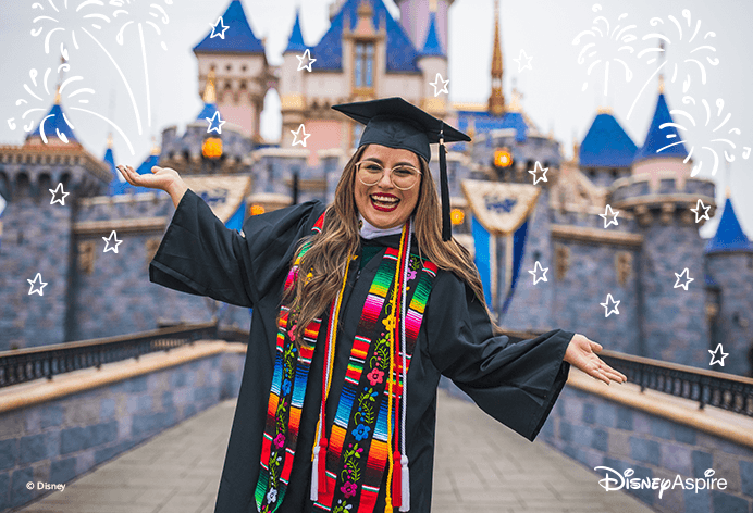 Disney Aspire; Woman smiling with in graduate robes and cap in front of a castle
